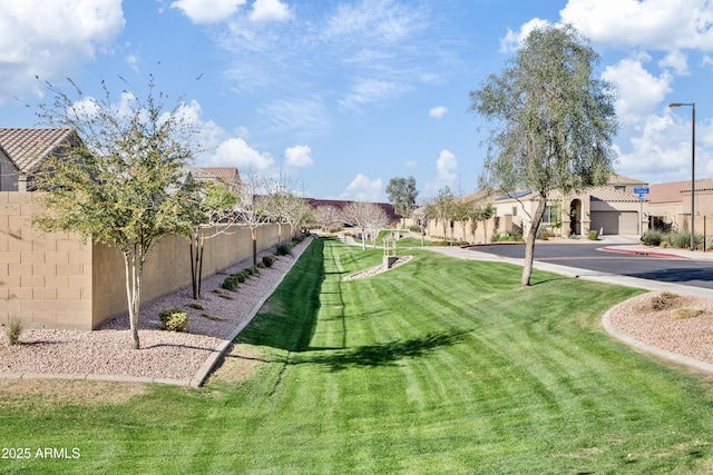 surrounding community with a residential view, a lawn, and fence