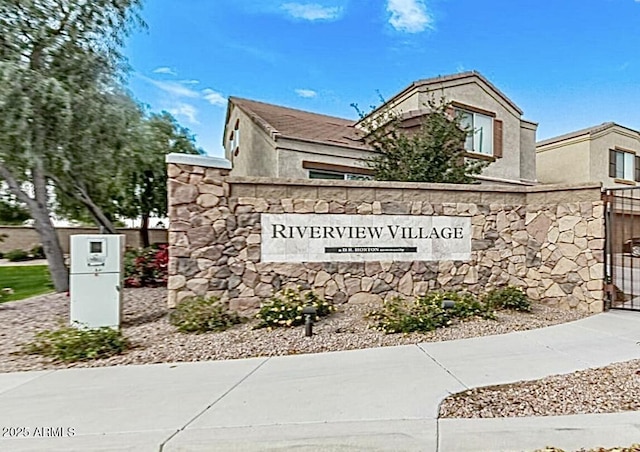 community / neighborhood sign featuring a gate