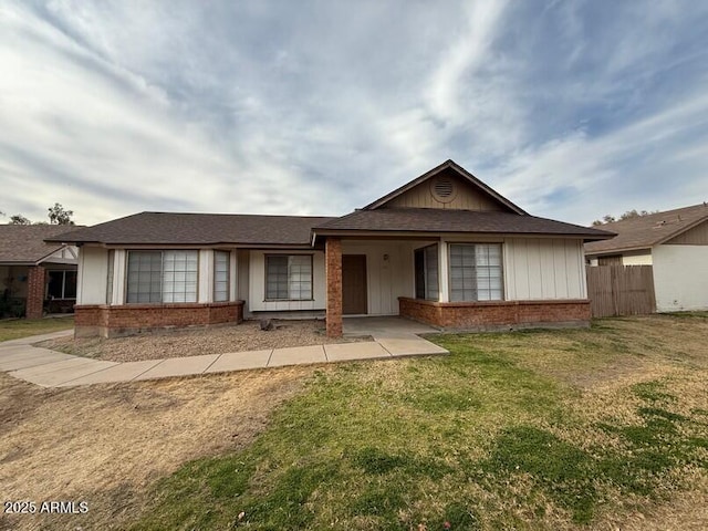 ranch-style home featuring a front yard