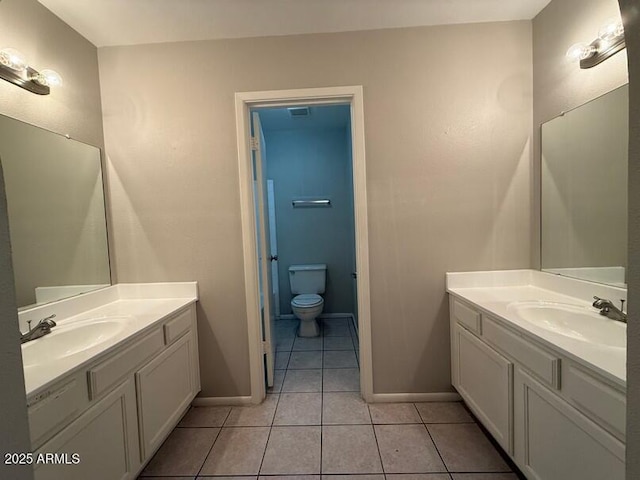 bathroom with vanity, tile patterned floors, and toilet