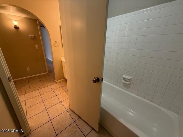 bathroom featuring vanity, tile patterned floors, and a tub