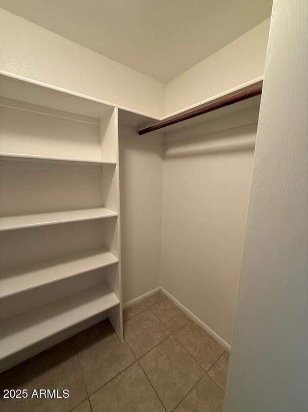 walk in closet with tile patterned flooring