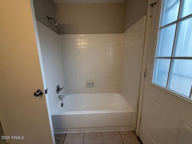 bathroom with tile patterned floors and  shower combination