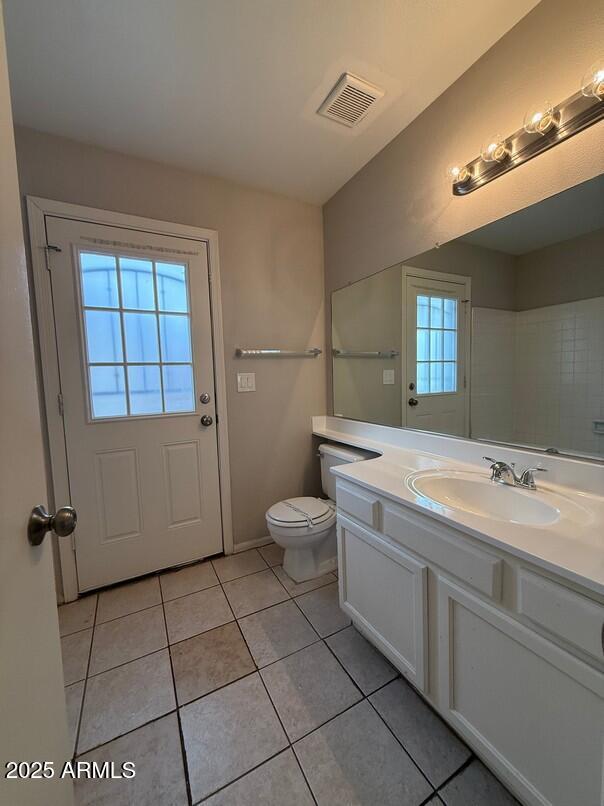 bathroom with vanity, tile patterned floors, and toilet