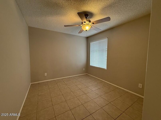 unfurnished room with ceiling fan, a textured ceiling, and light tile patterned flooring