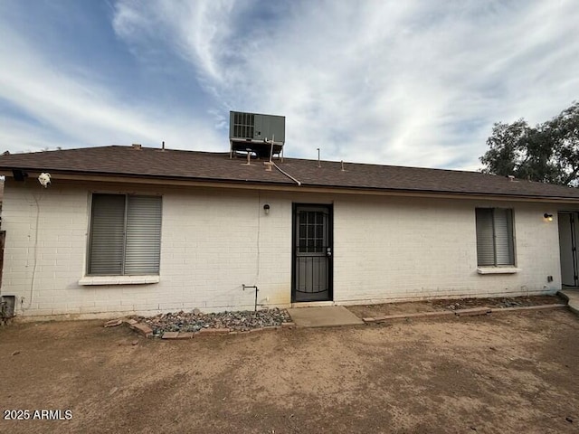 rear view of house with central AC unit