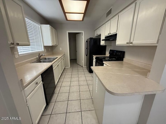 kitchen featuring sink, black appliances, white cabinets, light tile patterned flooring, and kitchen peninsula