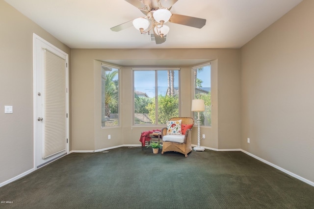 unfurnished room featuring ceiling fan and dark colored carpet