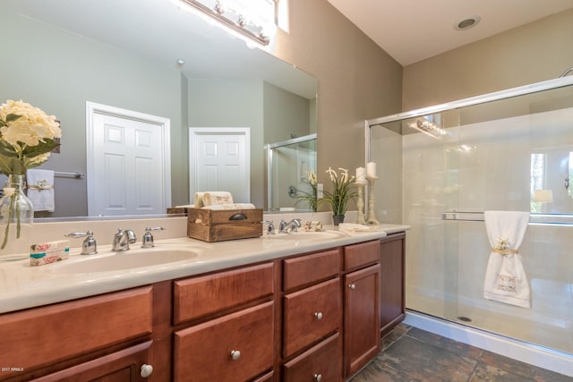 bathroom featuring vanity and a shower with shower door