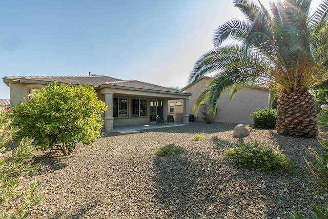 rear view of house featuring a patio