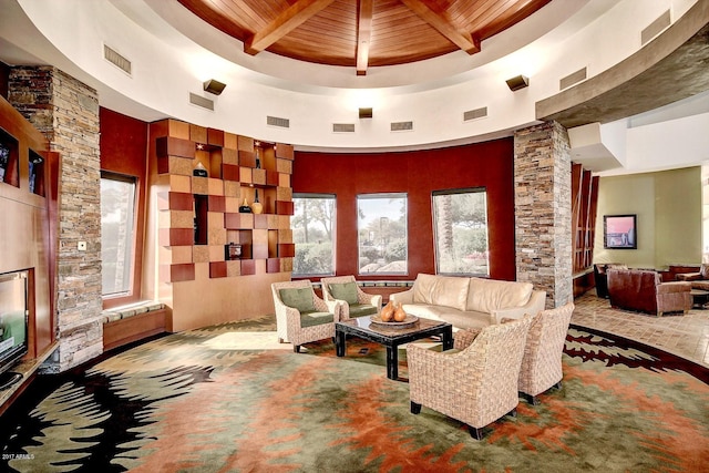 living room featuring beam ceiling, wooden ceiling, and a high ceiling