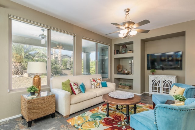 sunroom featuring ceiling fan