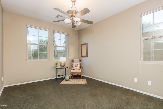 unfurnished room with dark colored carpet and ceiling fan