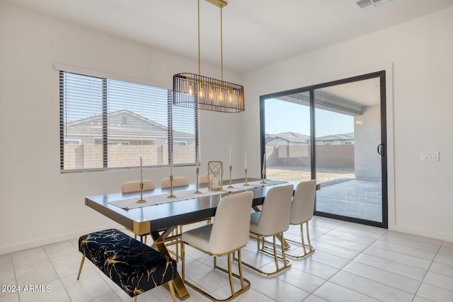 tiled dining area featuring a chandelier