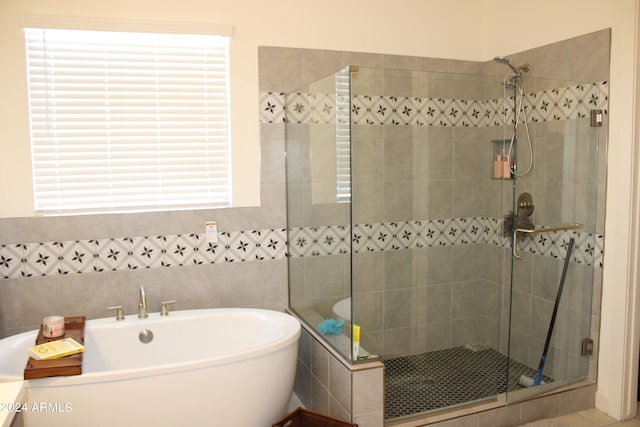 bathroom with shower with separate bathtub