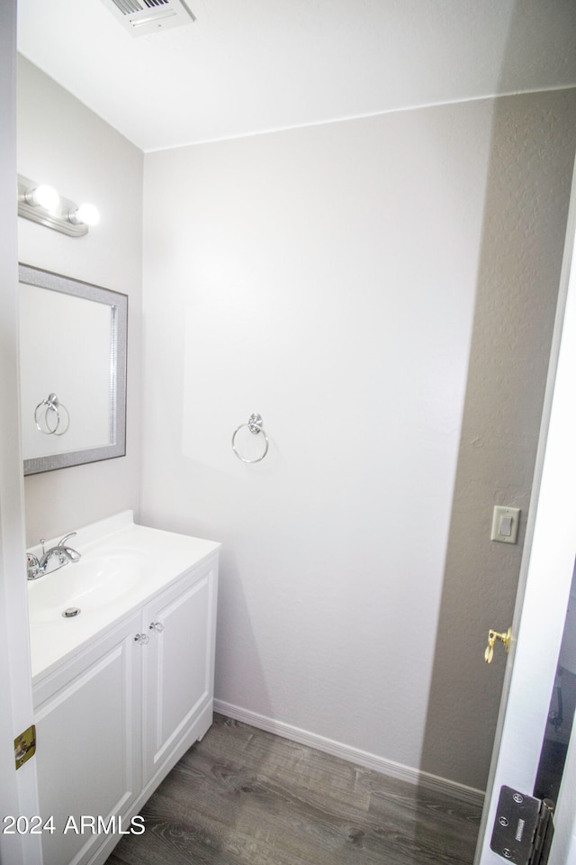 bathroom with vanity and hardwood / wood-style flooring