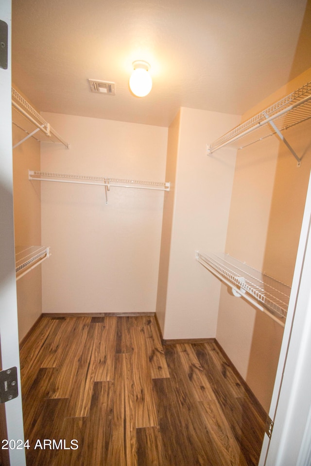 walk in closet with hardwood / wood-style floors