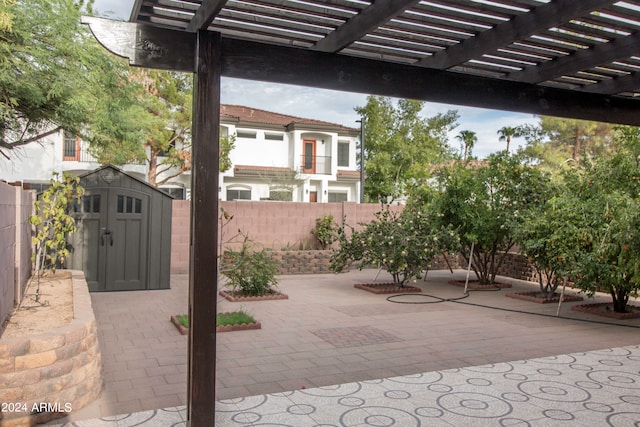 view of patio featuring a pergola and a shed