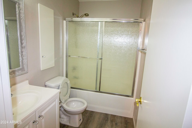 full bathroom with shower / bath combination with glass door, vanity, toilet, and wood-type flooring