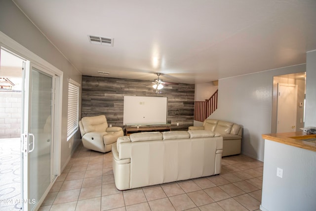 unfurnished living room with ceiling fan and light tile patterned flooring