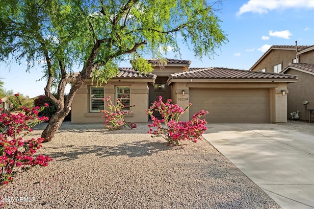 10239 E Salt Bush Dr, Scottsdale, AZ 85255 - view of front facade with an attached garage, stucco siding, a tile roof, and concrete driveway