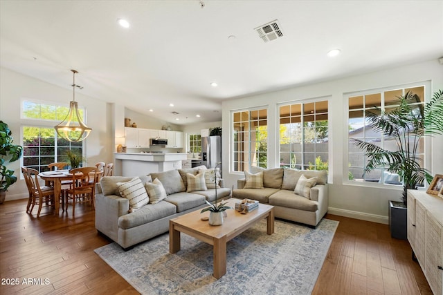 10239 E Salt Bush Dr, Scottsdale, AZ 85255 - living area featuring wood-type flooring, recessed lighting, baseboards, lofted ceiling, and visible vents