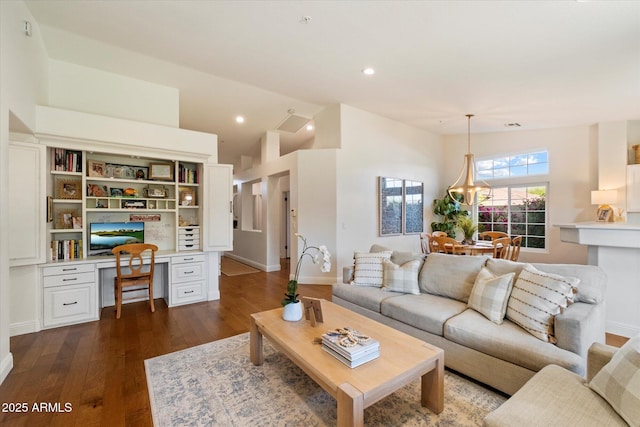10239 E Salt Bush Dr, Scottsdale, AZ 85255 - living area with lofted ceiling, built in study area, baseboards, recessed lighting, and dark wood-type flooring