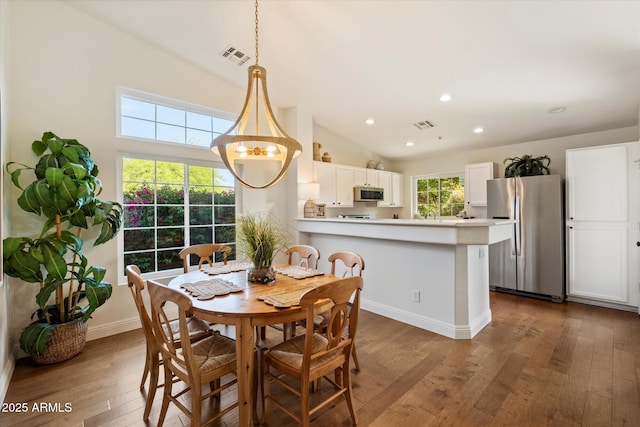 10239 E Salt Bush Dr, Scottsdale, AZ 85255 - dining area with wood-type flooring, high vaulted ceiling, recessed lighting, baseboards, and visible vents