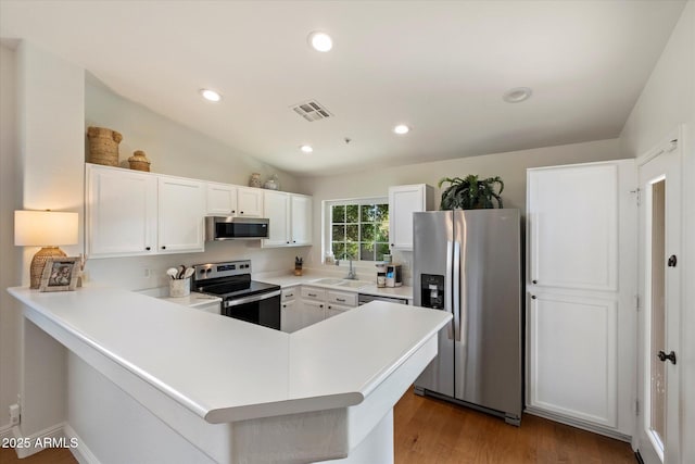 10239 E Salt Bush Dr, Scottsdale, AZ 85255 - kitchen featuring a peninsula, light countertops, white cabinets, a sink, and stainless steel appliances