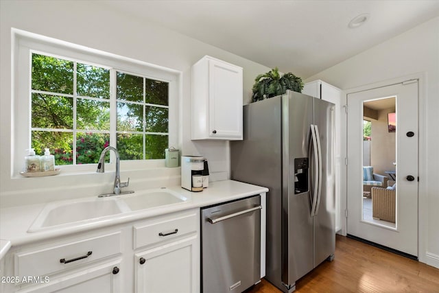 10239 E Salt Bush Dr, Scottsdale, AZ 85255 - kitchen featuring white cabinets, a sink, light countertops, stainless steel appliances, and wood finished floors