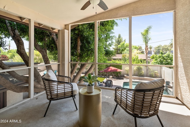 sunroom / solarium featuring ceiling fan and vaulted ceiling