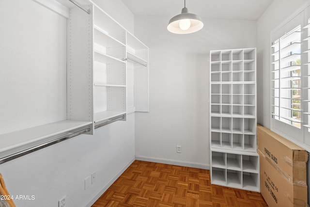 spacious closet with parquet flooring