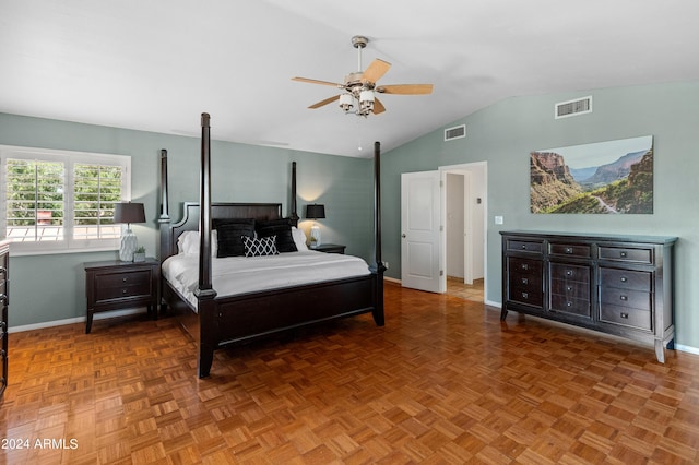 bedroom featuring ceiling fan, vaulted ceiling, and parquet flooring