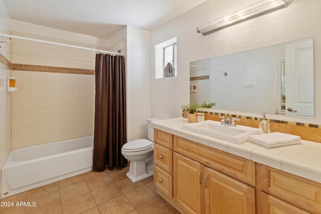 full bathroom with toilet, shower / tub combo with curtain, vanity, and tile patterned flooring