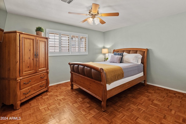 bedroom featuring ceiling fan and parquet flooring