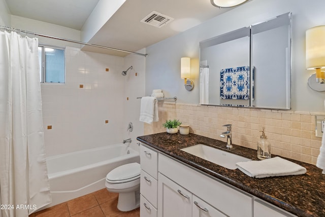 full bathroom featuring tile patterned floors, shower / bath combination with curtain, toilet, decorative backsplash, and vanity