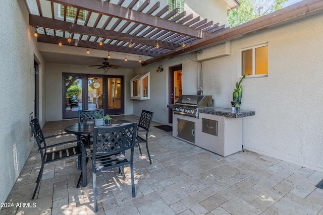 view of patio / terrace with a pergola, exterior kitchen, and a grill