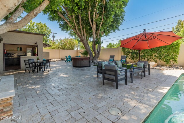 view of patio with a pool with hot tub