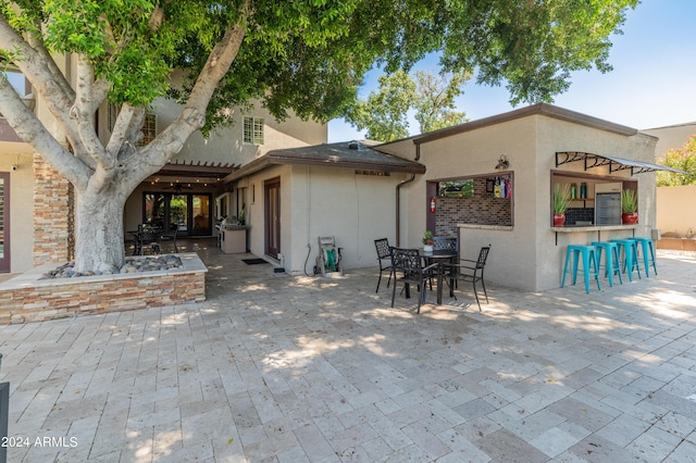 back of house with a patio area and an outdoor bar