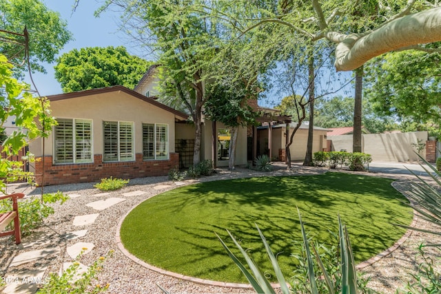 rear view of house featuring a lawn