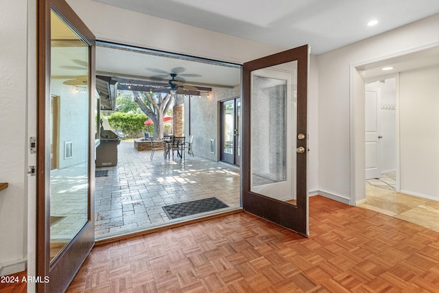 doorway with ceiling fan, french doors, and light parquet flooring