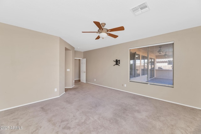 unfurnished room with ceiling fan and light carpet