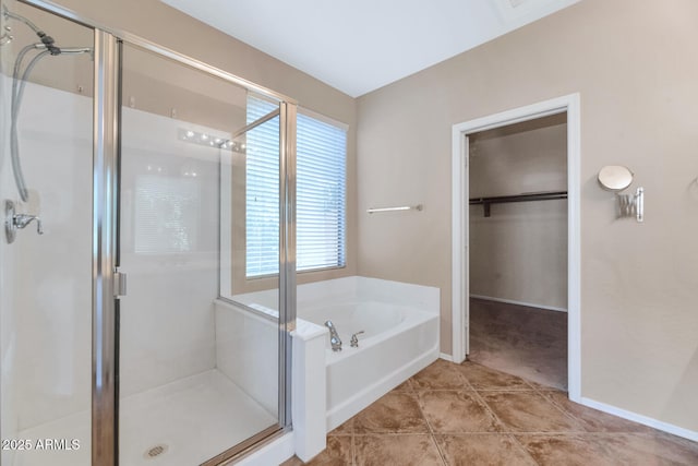 bathroom with tile patterned floors, a healthy amount of sunlight, and shower with separate bathtub