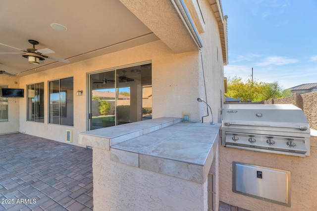 view of patio / terrace featuring an outdoor kitchen, grilling area, and ceiling fan