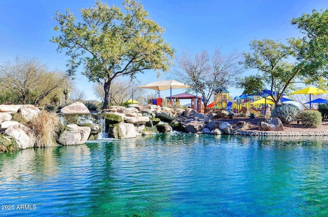 view of swimming pool featuring a playground