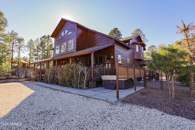 exterior space featuring a patio and a hot tub