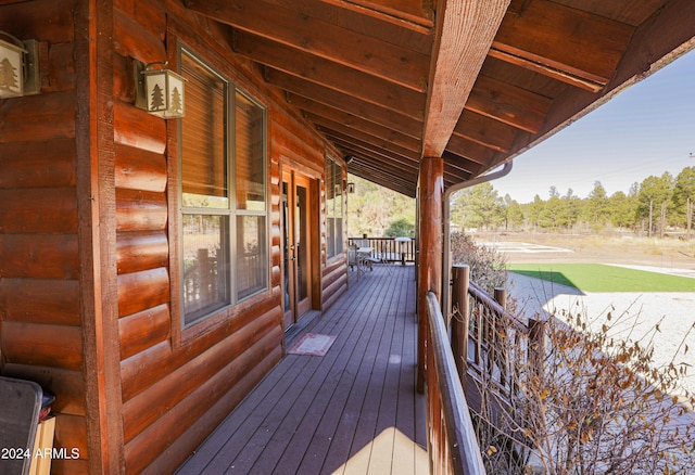 wooden terrace featuring covered porch