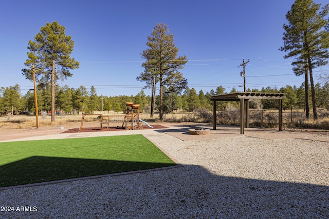 view of play area featuring a yard and an outdoor fire pit