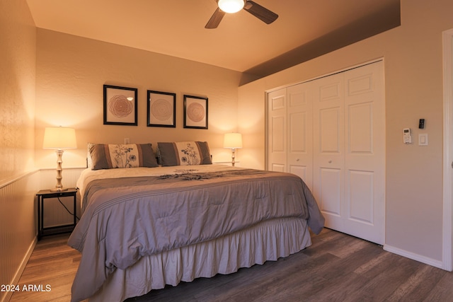 bedroom featuring ceiling fan, a closet, and dark wood-type flooring