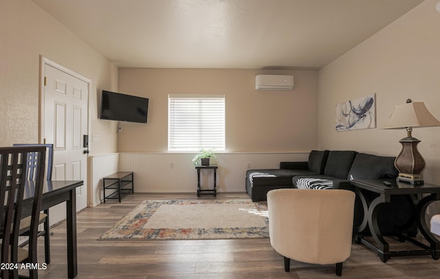 living room with wood-type flooring and a wall mounted AC